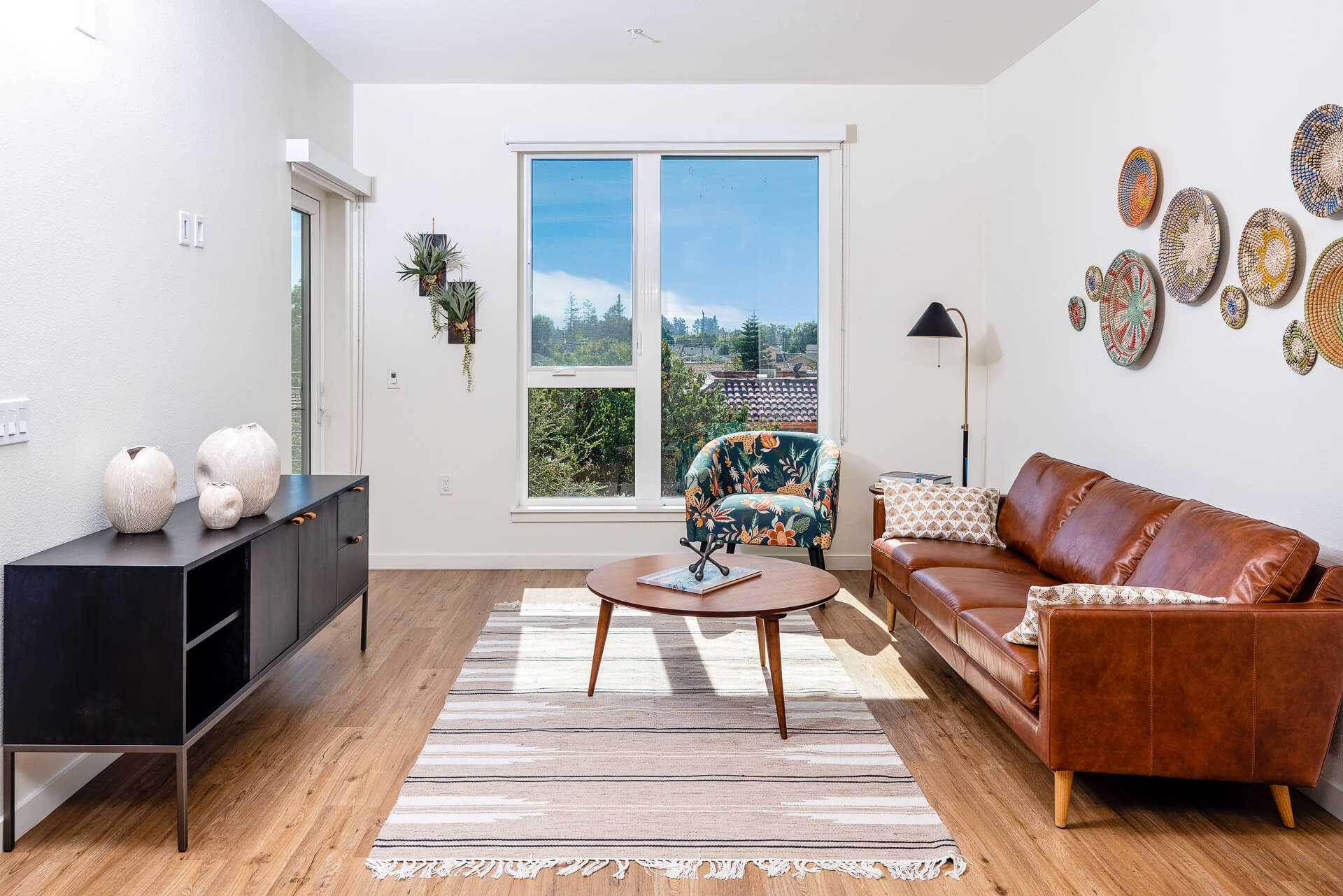 living room with window overlooking the woods